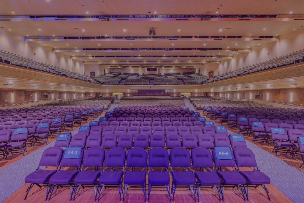 Wide view of the Jorgensen Center for the Performing Arts auditorium, showing rows of seats on the main floor and balcony.